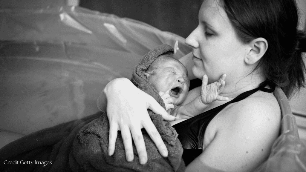 Newborn on mothers chest immediately after birth